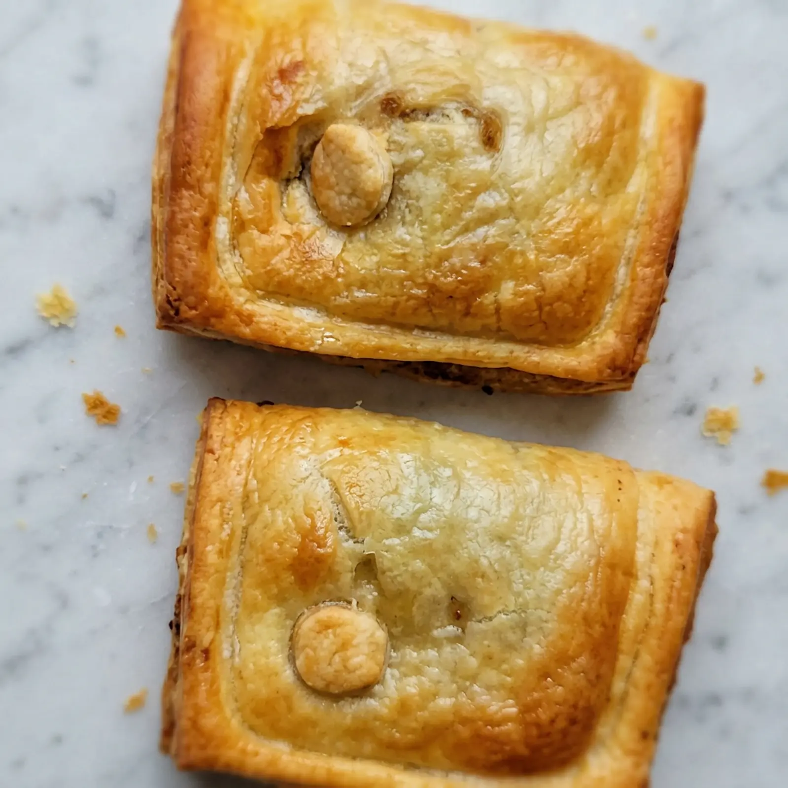 Two of Flo’s freshly baked golden pies served on marble